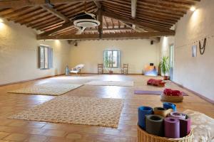 a large room with rugs on the floor and a ceiling at Borgo Villa Certano - Case Vacanza in Toscana in Siena