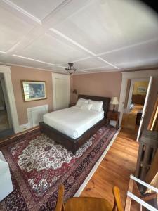 a bedroom with a bed and a rug at The old parsonage bed and breakfast in Kennebunkport +1 photo
