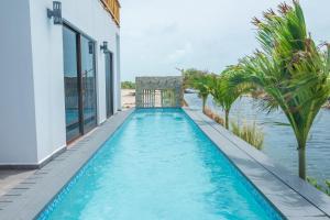 a swimming pool with a view of the water at Aruna Resort & Villas in San Pedro