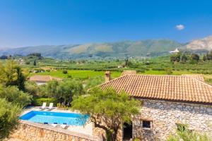 an external view of a villa with a swimming pool at Villa Demetra in Áyios Dhimítrios
