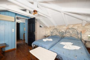 a bedroom with two blue beds in a room at Villa Demetra in Áyios Dhimítrios +21 photos