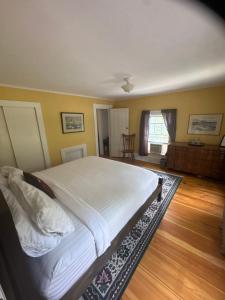 a bedroom with a large white bed in a room at The old parsonage bed and breakfast in Kennebunkport