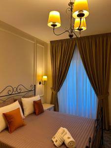 a bedroom with a bed with a large window at PIAZZADUOMO b&b Stilo in Stilo