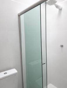 a shower with a glass door in a bathroom at Studios Congresso suites e Lofts Duplex in Brasília
