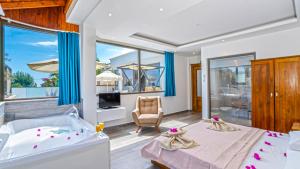a bedroom with a king sized bed and a balcony at Secluded Sea-View Family Escape-Villa Bella2 Sardunya in Üzümlü +73 photos