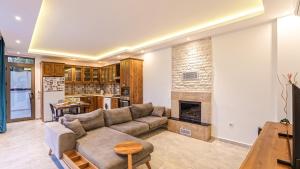 a living room with a couch and a fireplace at Secluded Sea-View Family Escape-Villa Bella2 Sardunya in Üzümlü
