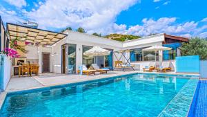 a house with a swimming pool and a patio at Secluded Sea-View Family Escape-Villa Bella2 Sardunya in Üzümlü