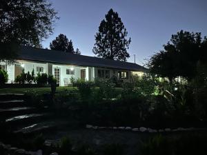 a white house with a garden in front of it at Rancho Meling in Camalú