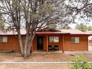 a log cabin with a tree in front of it at Lake and Mountains, 3BR 2BA in Show Low