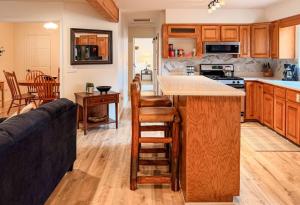 a kitchen with wooden cabinets and a counter top at Lake and Mountains, 3BR 2BA in Show Low