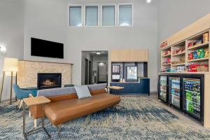 a living room with a couch and a fireplace at TownePlace Suites by Marriott Brookfield in Brookfield