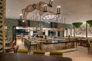 a restaurant with a bar with a monkey hanging from the ceiling at Hotel Paradox, Autograph Collection in Santa Cruz
