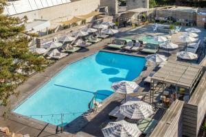 an overhead view of a pool with chairs and umbrellas at Hotel Paradox, Autograph Collection in Santa Cruz