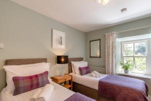 a bedroom with two beds and a window at 3 Bed in Castlemorris oc-94522 in Castlemartin