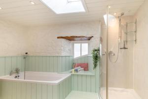 a bathroom with a shower and a sink and a tub at 3 Bed in Castlemorris oc-94522 in Castlemartin
