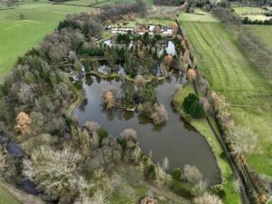 an aerial view of an island in a river at Egret Woody Park in Willand +7 photos