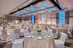 a large banquet hall with white tables and chairs at Singapore Marriott Tang Plaza Hotel in Singapore +113 photos