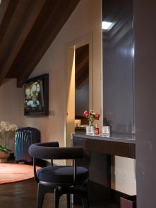 a room with two chairs and a table with a mirror at Palazzo Utini in Noceto