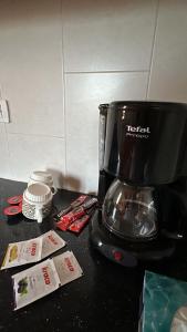a black coffee maker sitting on a counter withacist at Guest House Keli in Nënshat