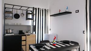 a kitchen with a table and a counter with pans at Aura Apartments in Pompei