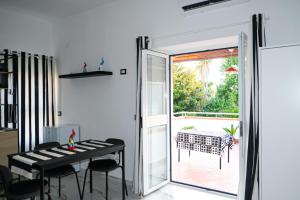 a dining room with a table and a sliding glass door at Aura Apartments in Pompei