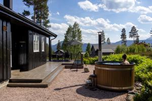 a hot tub in a yard next to a house at Chalet Vradal in Vradal