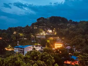 a town on a hill at night at Sobasee Holiday Bungalow in Kandy