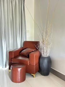 a brown leather couch and a black vase in a room at Angkor Sweet Night Hotel in Siem Reap +111 photos