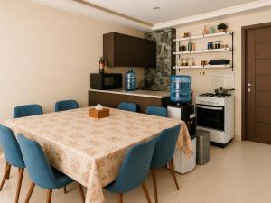 a dining room with a table and blue chairs at chalet in Saint remon in Al ‘Ayn