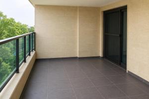 an empty balcony of a building with a window at chalet in Saint remon in Al ‘Ayn