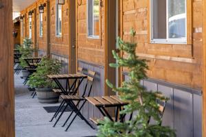 a row of tables and chairs outside a building at The Evergreen in West Yellowstone +19 photos