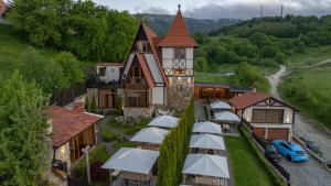 an aerial view of a building with a bunch of umbrellas at Alpine Castle Hotel in Dilijan