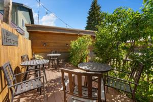 a patio with tables and chairs and a fence at The Evergreen in West Yellowstone