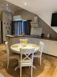 a kitchen with a table and chairs in a room at 't Gorsje in Goedereede