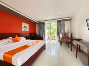 a hotel room with a large bed and a desk at Angkor Sweet Night Hotel in Siem Reap