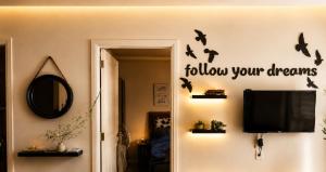 a living room with a tv and bats on the wall at chalet in Saint remon in Al ‘Ayn