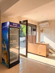 a soda machine in a room with a glass door at Suli Hostel in Tbilisi City