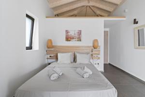 a bedroom with a large bed with two pillows at Πασιθεα in Spartokhórion +14 photos
