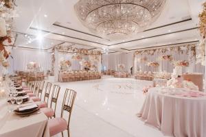 a banquet hall with tables and chairs and a chandelier at Renaissance Newport Beach Hotel in Newport Beach +107 photos