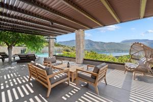 a patio with chairs and a table with a view at Πασιθεα in Spartokhórion