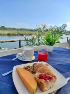 a white plate with food on a table with a table cloth at B&B Torre del Lago 1 in Foce Varano
