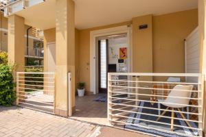 a balcony with a white railing in front of a house at Pepita del Lago - Piscina e Parcheggio privato in Lenno