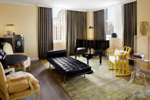 a living room with a grand piano and chairs at Riggs Washington DC in Washington, D.C. +81 photos