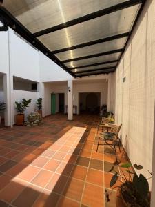a large room with a ceiling and a patio at Casa Natus Hostal in Zapatoca
