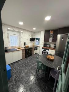a kitchen with a table and a counter top at La casa de Ángel in Llombera