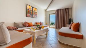 a living room with a couch and a table at Intouriste Hotel & Suites in Agadir
