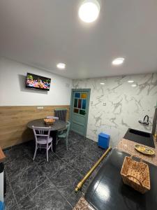 a dining room with a table and a tv on the wall at La casa de Ángel in Llombera