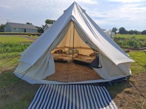 a white tent on the grass in a field at Sleep4GlampingTent-NearTralee-Countryside in Tralee