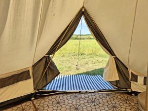 a mattress in a tent with a view of a field at Sleep4GlampingTent-NearTralee-Countryside in Tralee