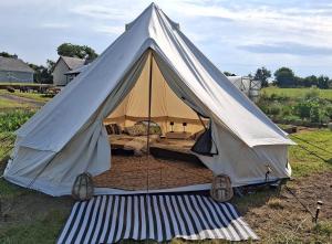 a large tent with a mattress in a field at Sleep4GlampingTent-NearTralee-Countryside in Tralee